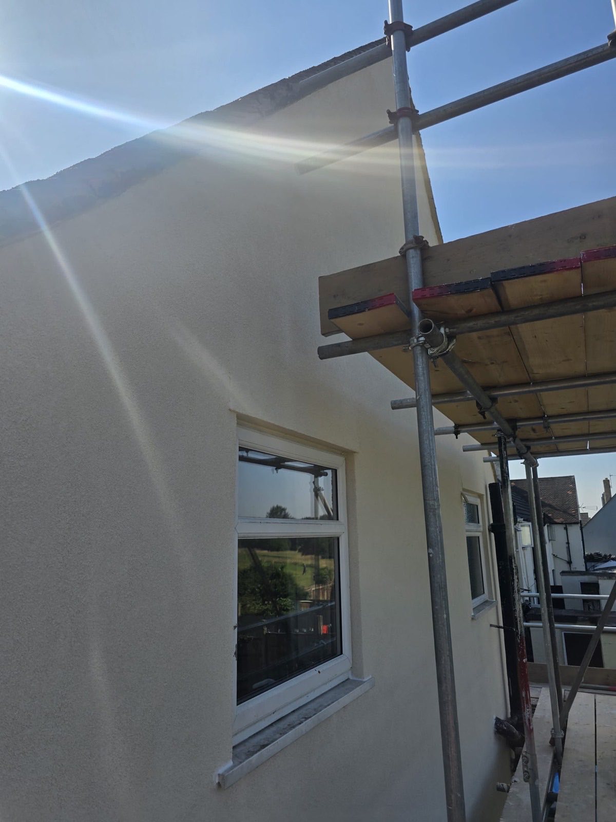 Rendered gable end with crisp edges and chimney detail against blue sky